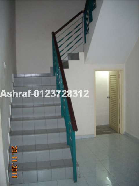Staircase leading upstairs with store below