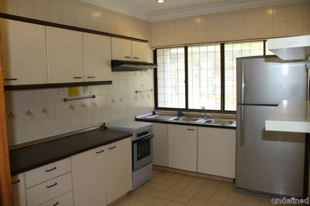 Kitchen with cabinets and large fridge